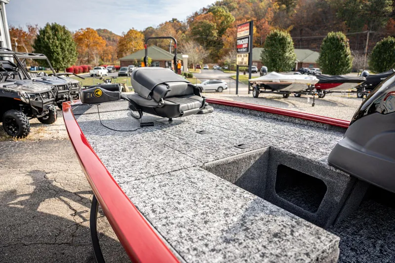 Slide: The Image of 2025 Bass Tracker Pro Team 170 boat with gray deck, parked outdoors. - 8