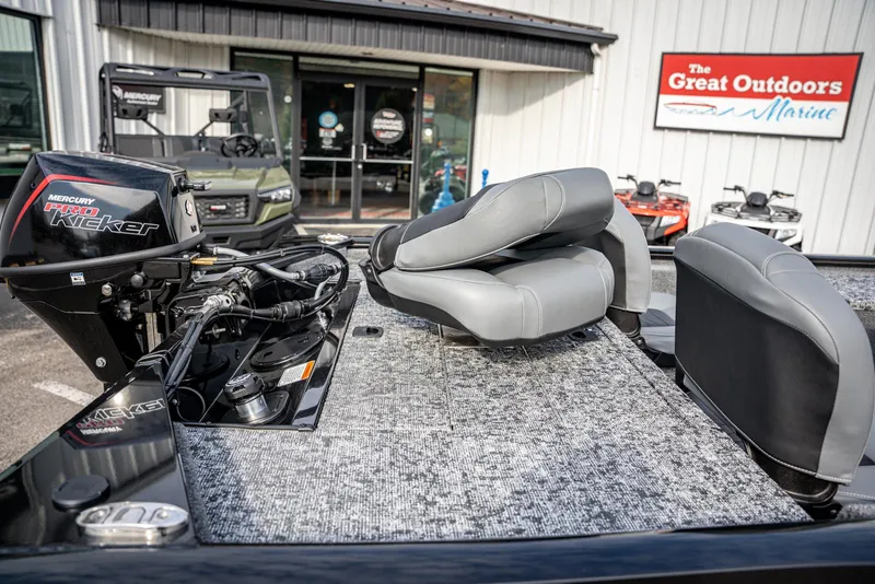 Slide: The Image of 2025 Bass Tracker Pro Team 170 boat with Mercury motor at outdoor marine store. - 11