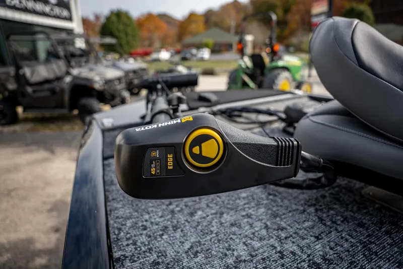 Slide: The Image of Close-up of a 2025 Bass Tracker Pro Team 170 boat control panel. - 6