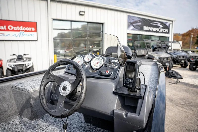 Slide: The Image of 2025 Bass Tracker Pro Team 170 dashboard with steering wheel and gauges at dealership. - 9