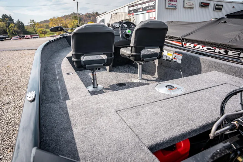 Slide: The Image of 2025 Bass Tracker Super Guide V-16 SC boat interior with dual seats and carpeted deck. - 13