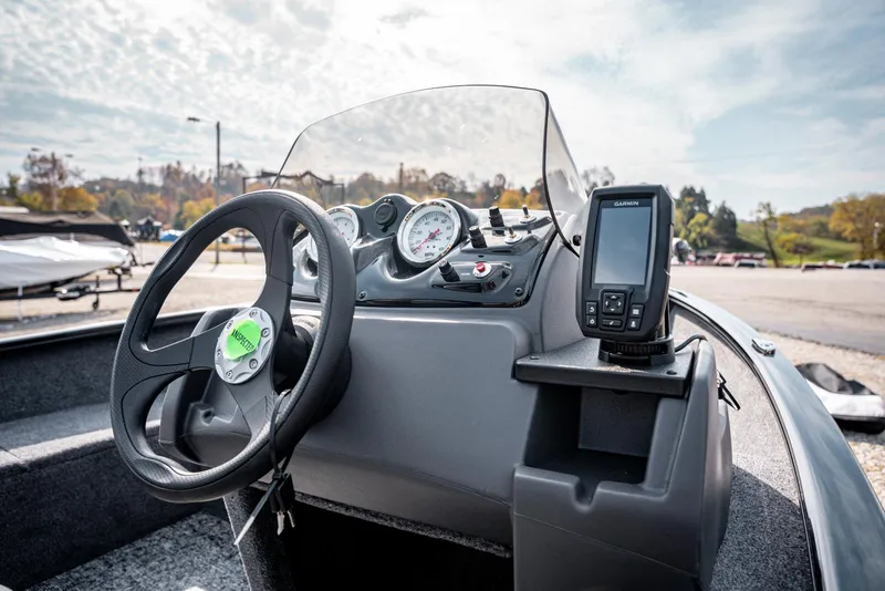 Slide: The Image of 2025 Bass Tracker Super Guide V-16 SC boat dashboard with steering wheel and navigation system. - 14
