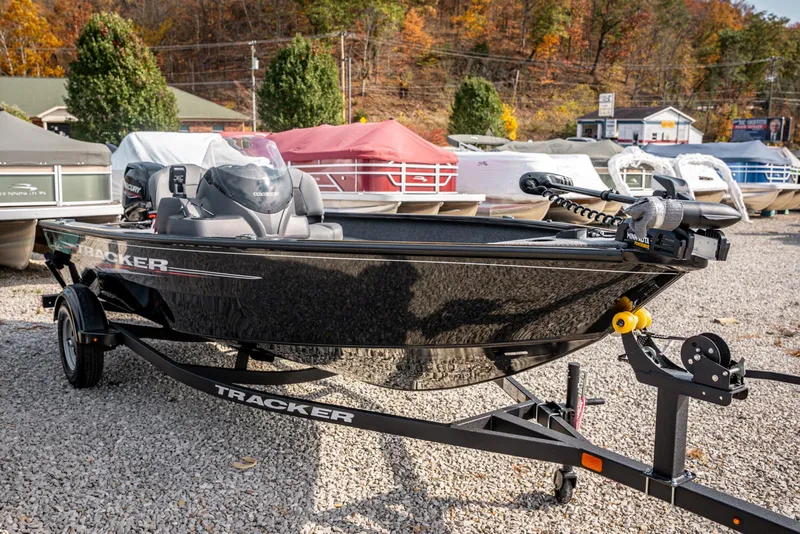 Slide: The Image of 2025 Bass Tracker Super Guide V-16 SC boat on trailer, outdoor showroom setting. - 3