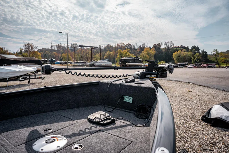 Slide: The Image of 2025 Bass Tracker Super Guide V-16 SC boat at a marina, featuring a trolling motor. - 5