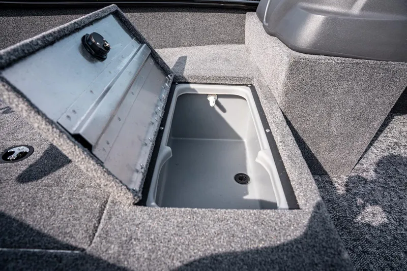 Slide: The Image of 2025 Bass Tracker Super Guide V-16 SC boat storage compartment, open and empty. - 9