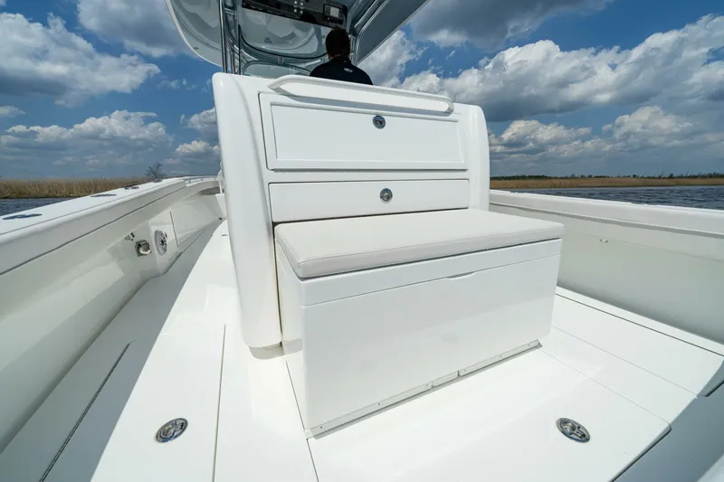 Slide: The Image of 2025 Valhalla V-29 Hybrid boat interior with white seating under a blue sky. - 10