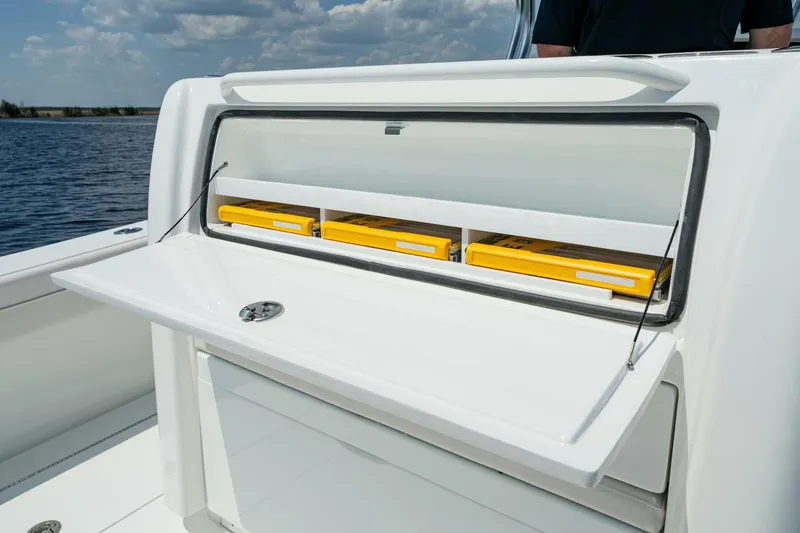 Slide: The Image of 2025 Valhalla V-29 Hybrid boat storage compartment with yellow containers, open on deck. - 11