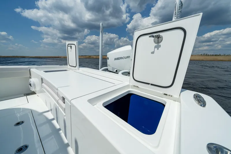 Slide: The Image of 2025 Valhalla V-29 Hybrid boat with open storage compartments on a sunny day. - 13