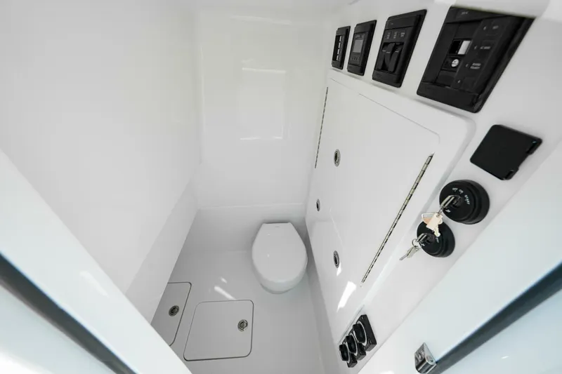 Slide: The Image of 2025 Valhalla V-29 Hybrid boat interior with modern controls and compact toilet. - 16