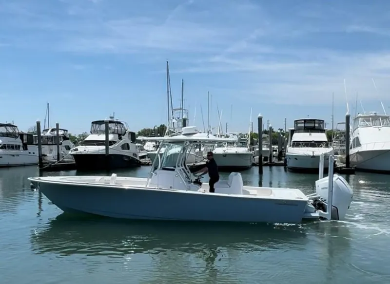 Slide: The Image of 2025 Valhalla Boatworks V-29 Hybrid cruising in a marina with yachts in the background. - 26