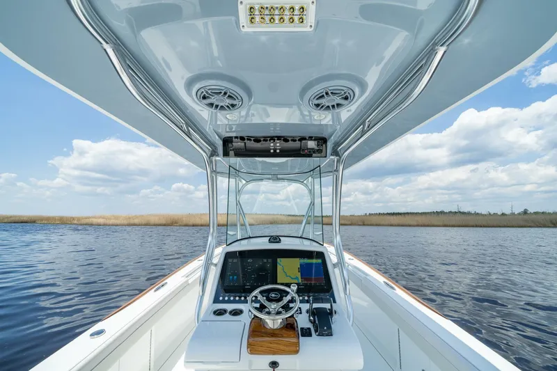 Slide: The Image of Valhalla Boatworks V-29 Hybrid 2025, sleek helm design on open water. - 8