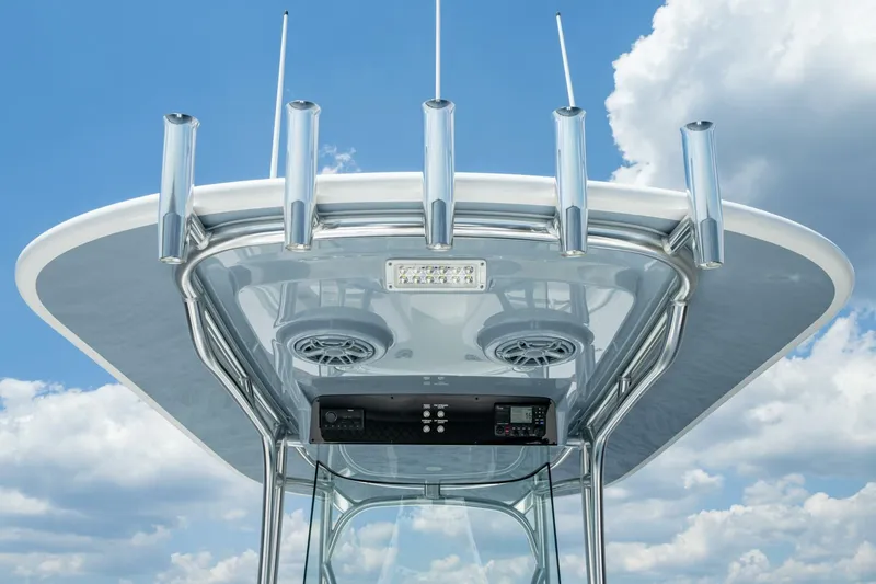 Slide: The Image of 2025 Valhalla Boatworks V-29 Hybrid T-top with rod holders against a cloudy sky. - 9