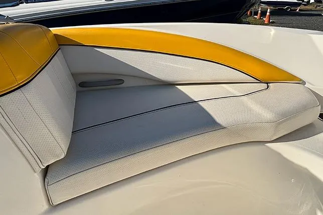 Slide: The Image of 2012 Bayliner 185 Bowrider interior with yellow and white seating. - 11