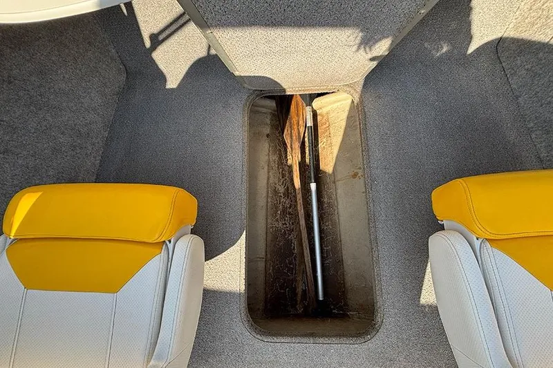 Slide: The Image of Interior of 2012 Bayliner 185 Bowrider with yellow seats and storage compartment. - 16
