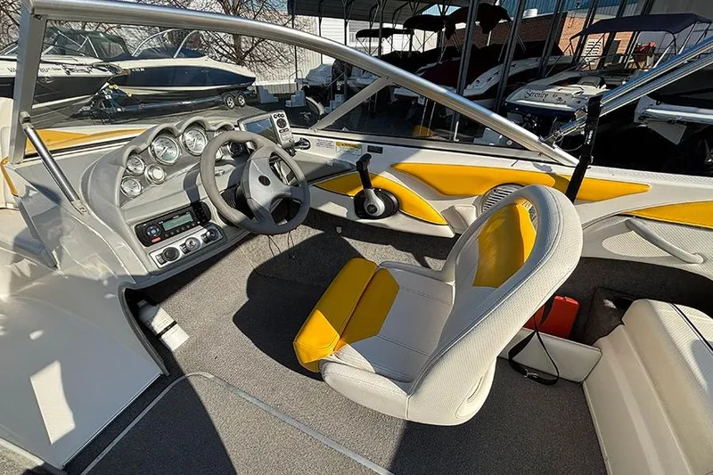 Slide: The Image of 2012 Bayliner 185 Bowrider interior with yellow accents and modern dashboard. - 9