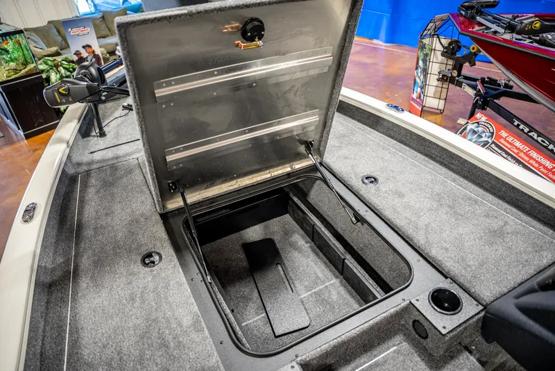 Slide: The Image of 2025 Bass Tracker PRO TEAM 190 boat with open storage compartment. - 10