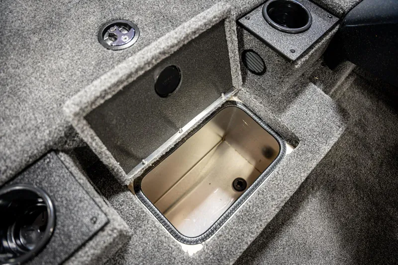 Slide: The Image of 2025 Bass Tracker PRO TEAM 190 boat storage compartment with carpeted interior. - 13