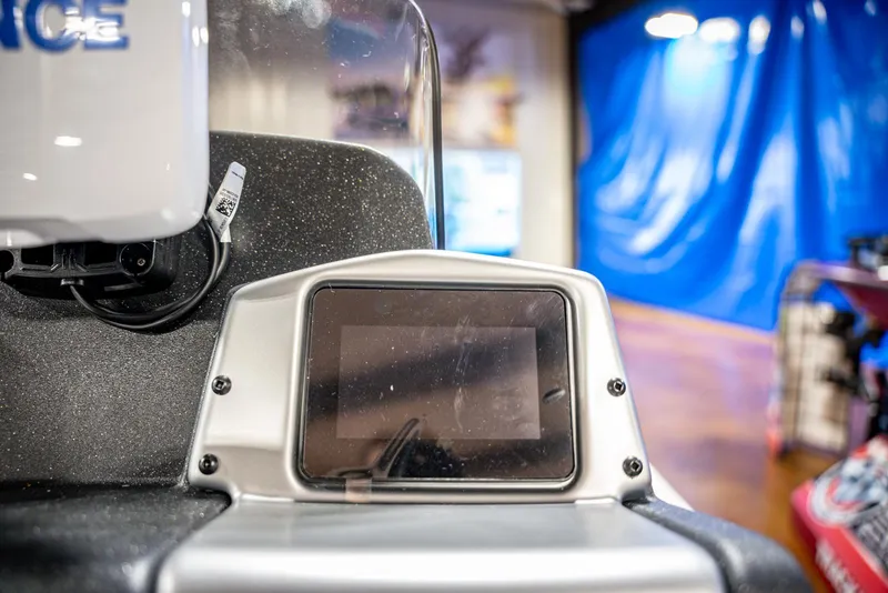 Slide: The Image of 2025 Bass Tracker PRO TEAM 190 dashboard with digital display in showroom. - 16