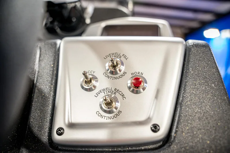 Slide: The Image of Control panel of 2025 Bass Tracker PRO TEAM 190 boat with switches and horn button. - 17