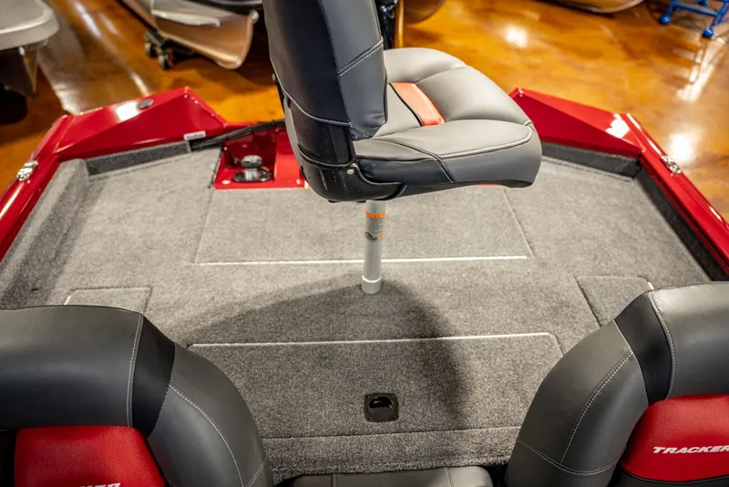 Slide: The Image of 2025 Bass Tracker Pro Team 175 boat interior with swivel seat and carpeted deck. - 16