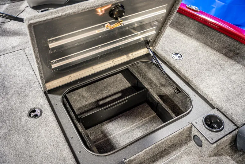 Slide: The Image of 2025 Bass Tracker Pro Team 175 storage compartment with open lid. - 8