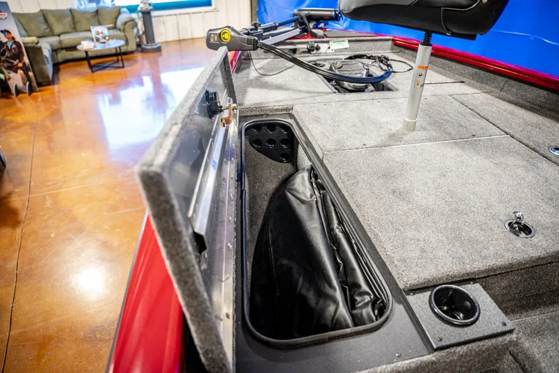 Slide: The Image of 2025 Bass Tracker Pro Team 175 boat interior with storage compartment and seating. - 9