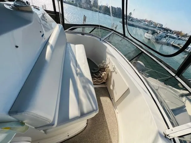 Slide: The Image of 1999 Silverton 392 Motor Yacht interior with seating, overlooking marina. - 13