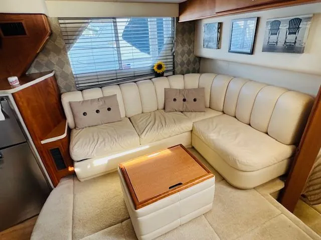 Slide: The Image of Luxurious interior of 1999 Silverton 392 Motor Yacht with cream leather seating and wooden accents. - 16