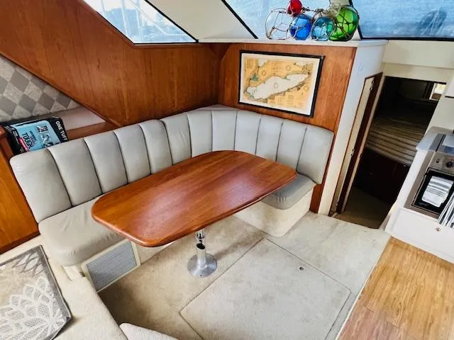 Slide: The Image of Interior of 1999 Silverton 392 Motor Yacht with cozy dining area and map decor. - 17