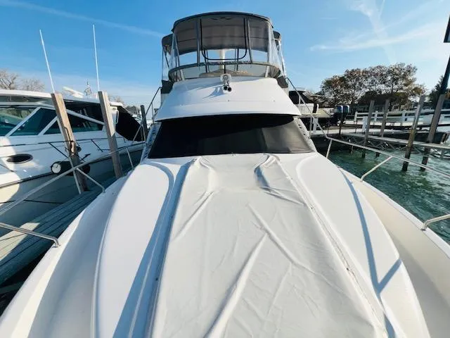 Slide: The Image of 1999 Silverton 392 Motor Yacht docked at marina, front view. - 2