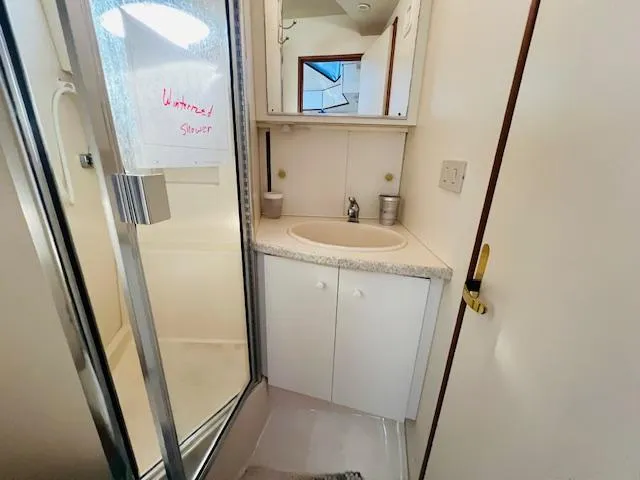 Slide: The Image of Bathroom in 1999 Silverton 392 Motor Yacht with shower and sink. - 22