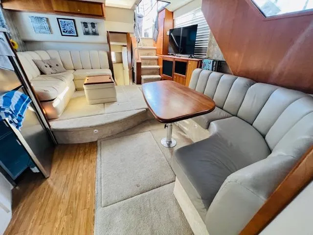 Slide: The Image of Interior of 1999 Silverton 392 Motor Yacht with plush seating and wooden accents. - 23