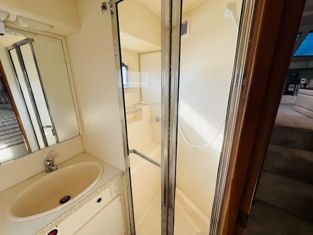 Slide: The Image of Bathroom interior of 1999 Silverton 392 Motor Yacht with shower and sink. - 27