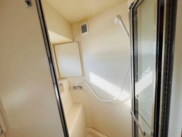 Slide: The Image of Shower area in 1999 Silverton 392 Motor Yacht, featuring white interior and modern fixtures. - 28