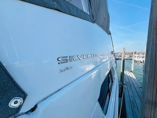 Slide: The Image of 1999 Silverton 392 Motor Yacht docked at marina, side view. - 3