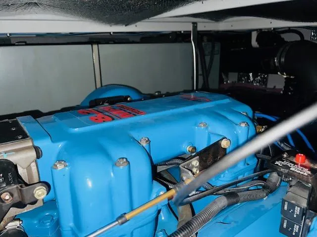 Slide: The Image of Engine compartment of a 1999 Silverton 392 Motor Yacht, featuring a blue engine. - 30