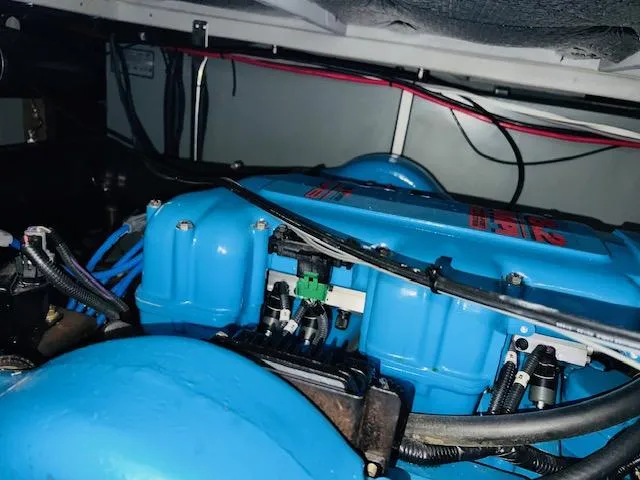 Slide: The Image of Engine compartment of 1999 Silverton 392 Motor Yacht with blue engine components. - 31