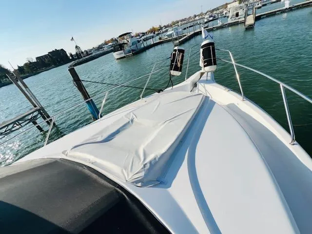 Slide: The Image of 1999 Silverton 392 Motor Yacht docked at marina, sunny day, calm waters. - 4