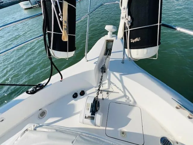 Slide: The Image of 1999 Silverton 392 Motor Yacht bow with anchor and railing on calm water. - 5