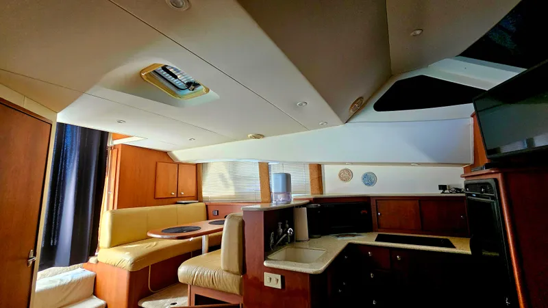 Slide: The Image of Interior of 2005 Silverton 330 Sport Bridge yacht with dining and kitchen area. - 13