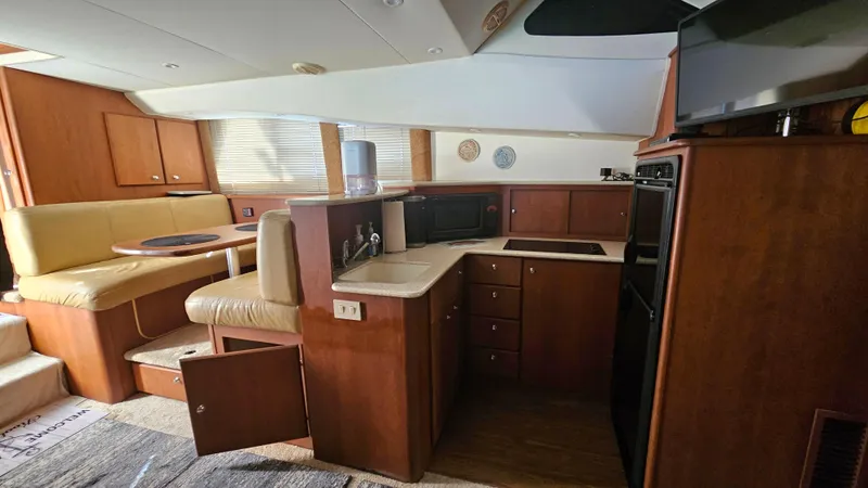 Slide: The Image of Interior of 2005 Silverton 330 Sport Bridge yacht with kitchen and dining area. - 16