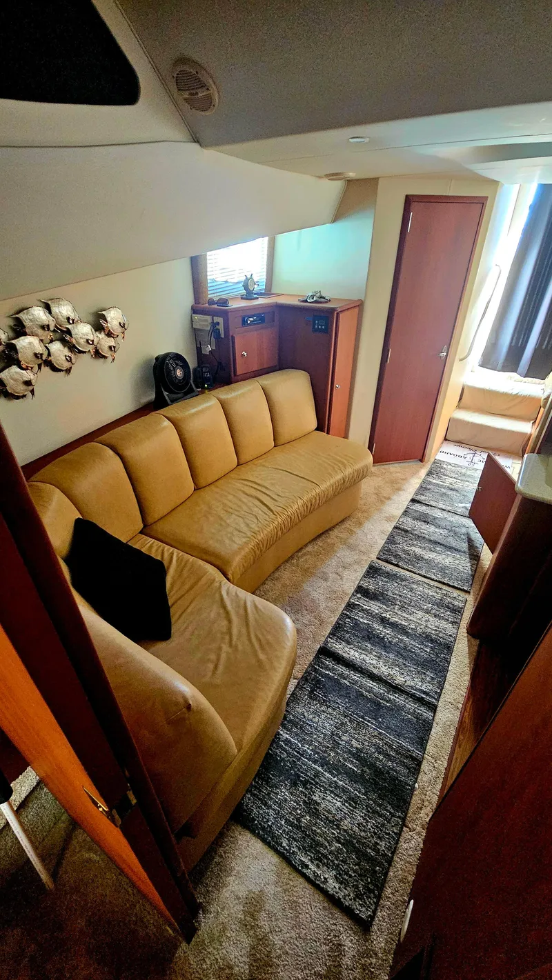 Slide: The Image of Interior of 2005 Silverton 330 Sport Bridge with beige sofa and modern decor. - 17