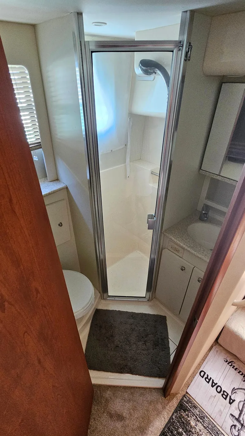 Slide: The Image of 2005 Silverton 330 Sport Bridge bathroom with shower, sink, and toilet. - 19
