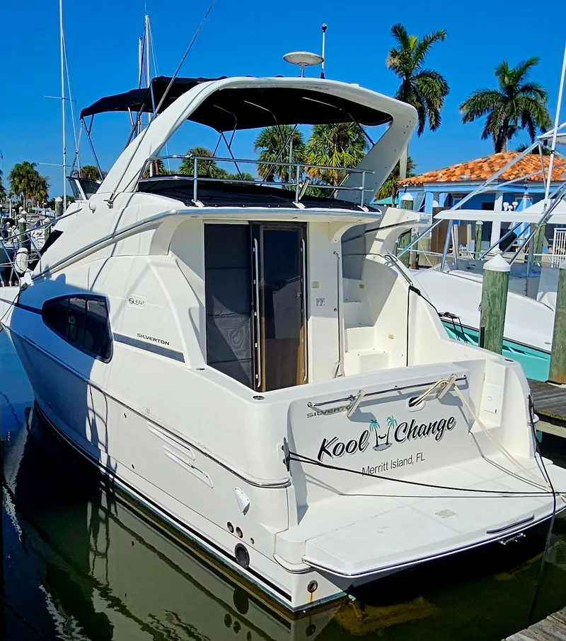 Slide: The Image of 2005 Silverton 330 Sport Bridge yacht docked in a sunny marina. - 3