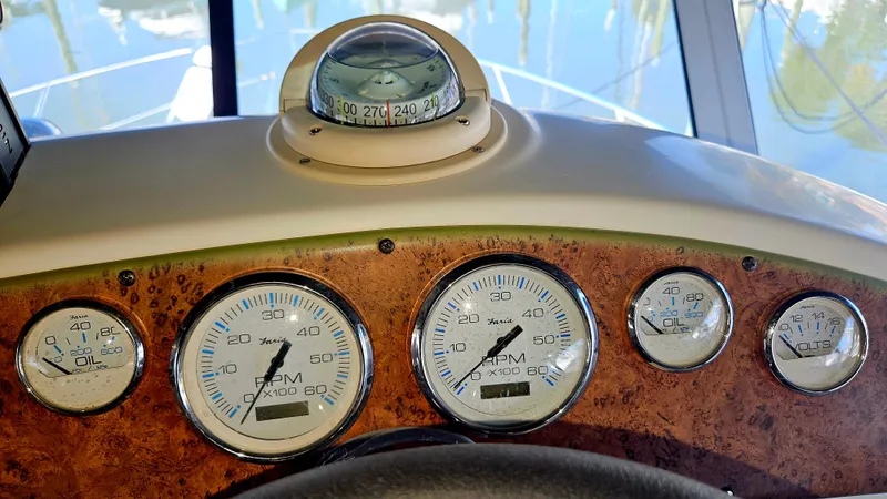 Slide: The Image of Dashboard of a 2005 Silverton 330 Sport Bridge with gauges and compass. - 32
