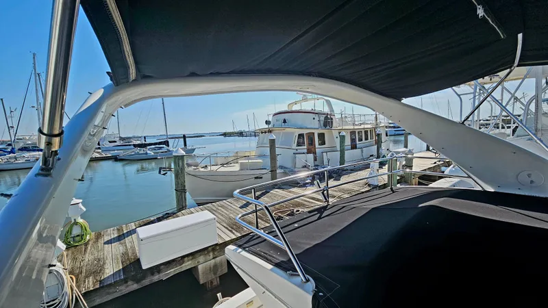 Slide: The Image of 2005 Silverton 330 Sport Bridge docked at a marina with other boats. - 34