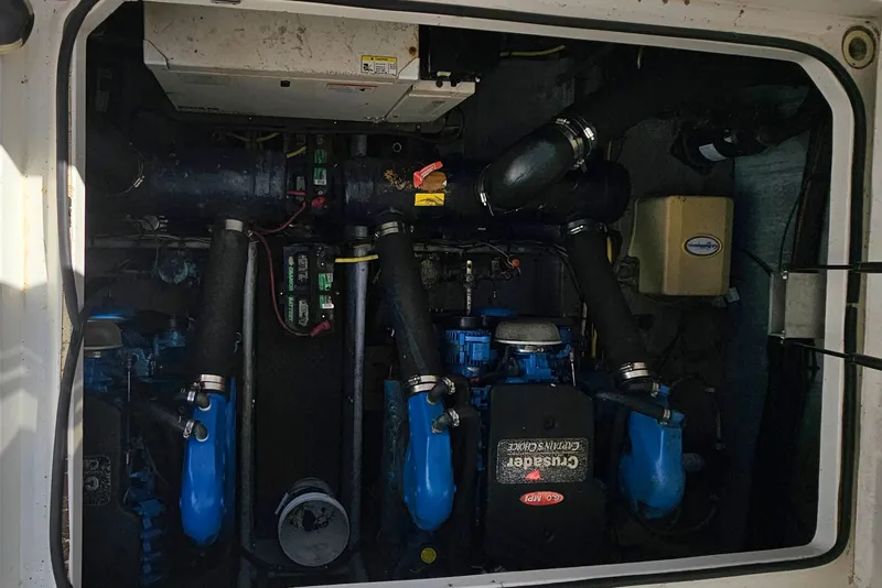 Slide: The Image of Engine compartment of a 2005 Silverton 330 Sport Bridge boat, featuring dual Crusader engines. - 38