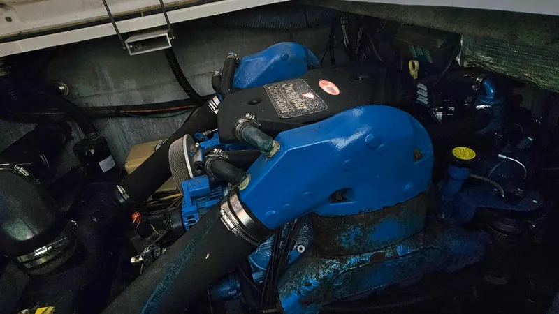 Slide: The Image of Engine compartment of a 2005 Silverton 330 Sport Bridge with blue components. - 39