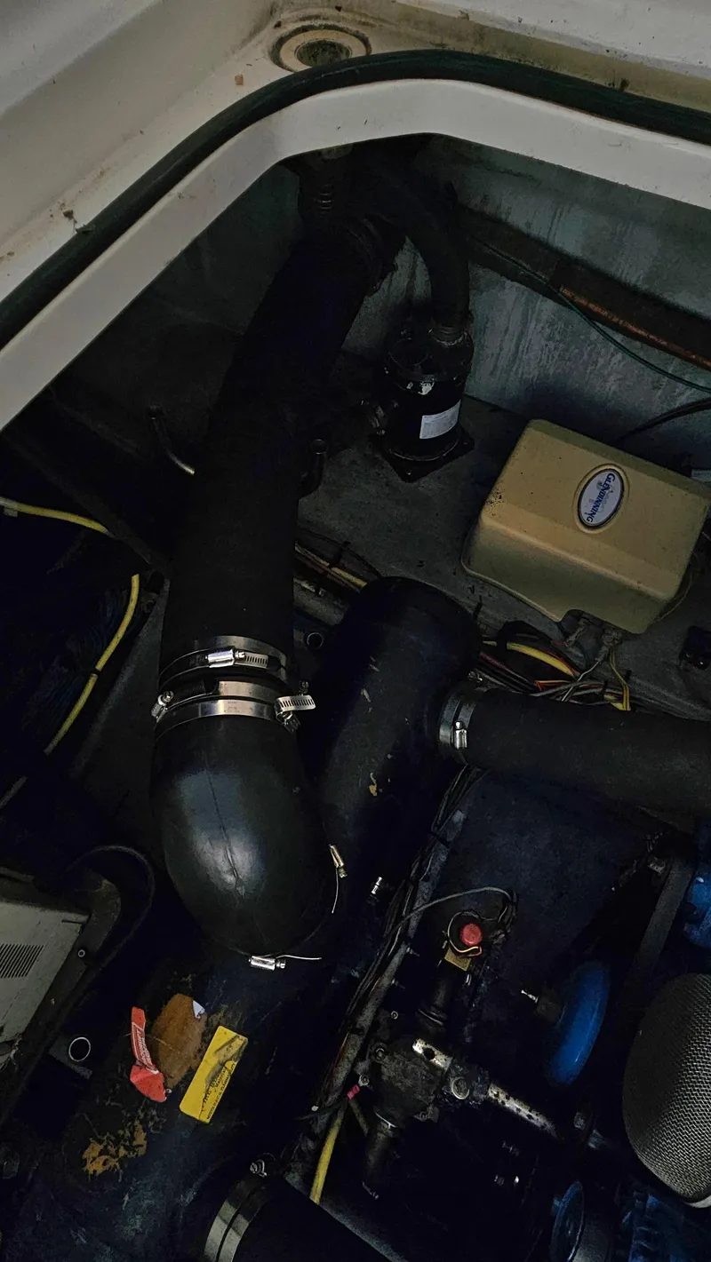 Slide: The Image of Engine compartment of a 2005 Silverton 330 Sport Bridge with visible hoses and components. - 41