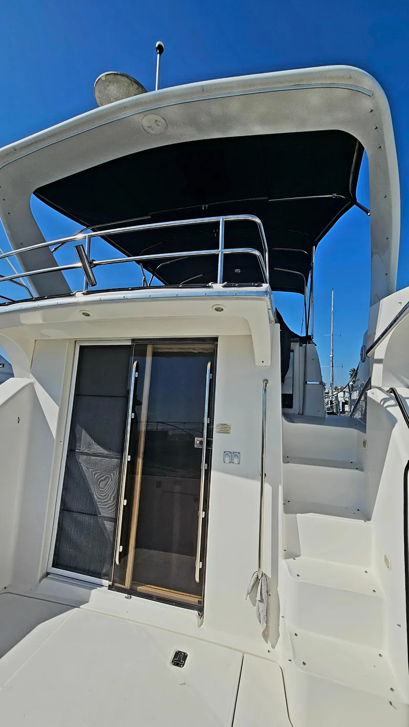 Slide: The Image of 2005 Silverton 330 Sport Bridge yacht with upper deck and sliding glass doors. - 45